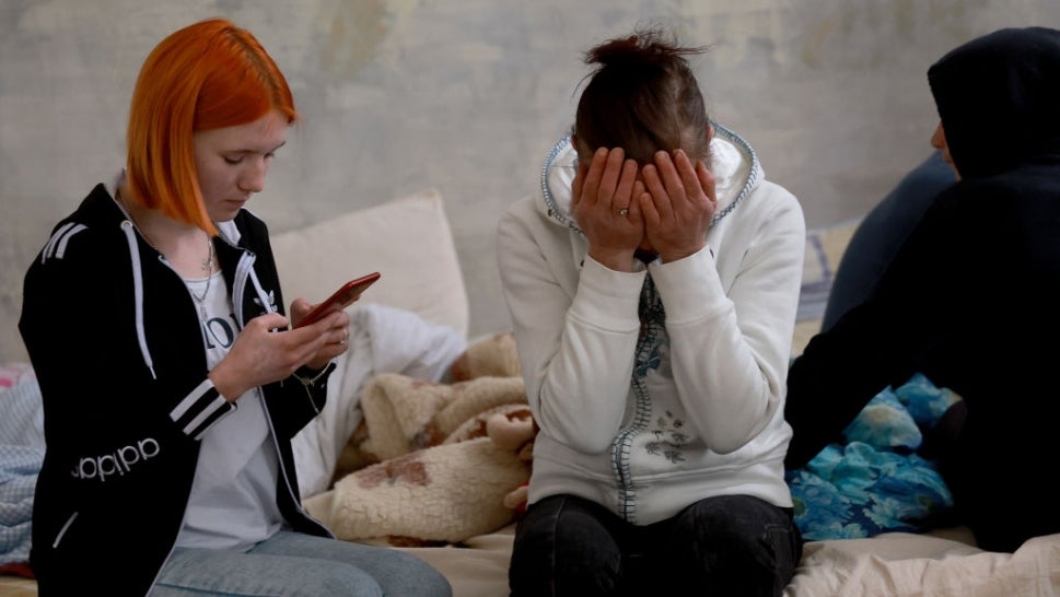 Elena Kravchenko (L) and Yulia Slobudchikova sit on a bed together in a shelter for displaced people after having to flee their hometown of Dnipro on April 04, 2022 in Lviv, Ukraine. Lviv has served as a stopover and shelter for the millions of Ukrainians fleeing the Russian invasion, either to the safety of nearby countries or the relative security of western Ukraine.