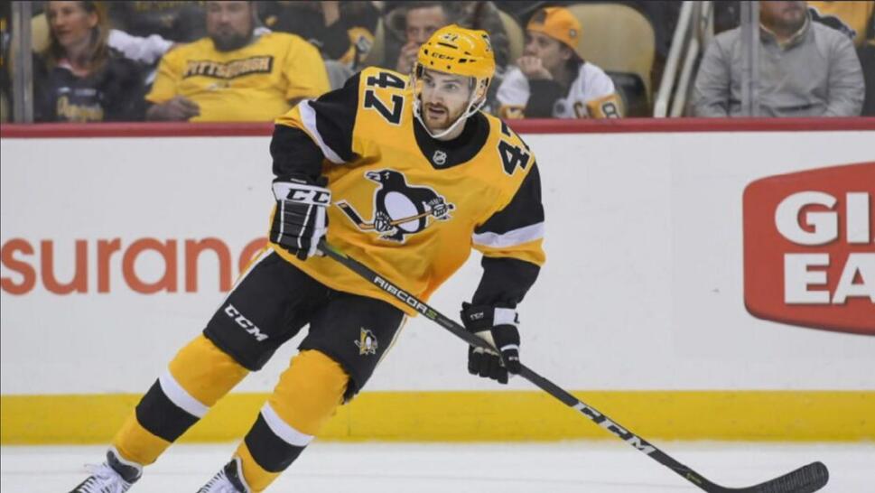 Adam Johnson playing hockey wearing Pittsburgh Penguins gear