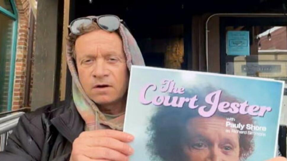 Pauly Shore holding poster for "The Court Jester"